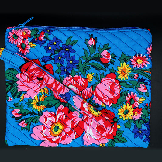 Quilted wristlet in blue with pink roses and sunflowers, front view