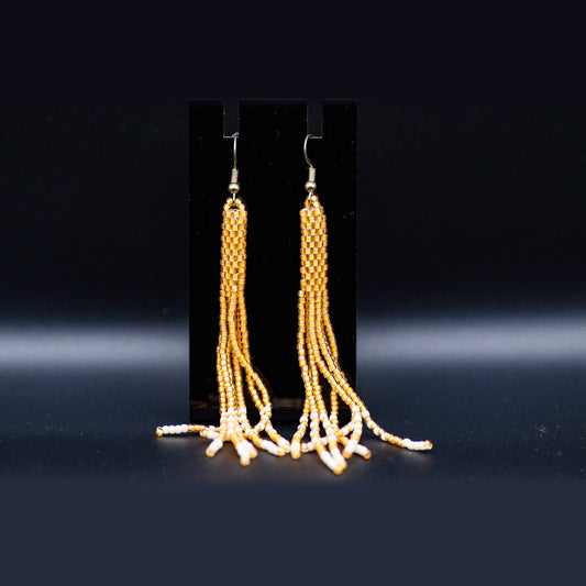 Fringe earrings in gold and cream beads, front view
