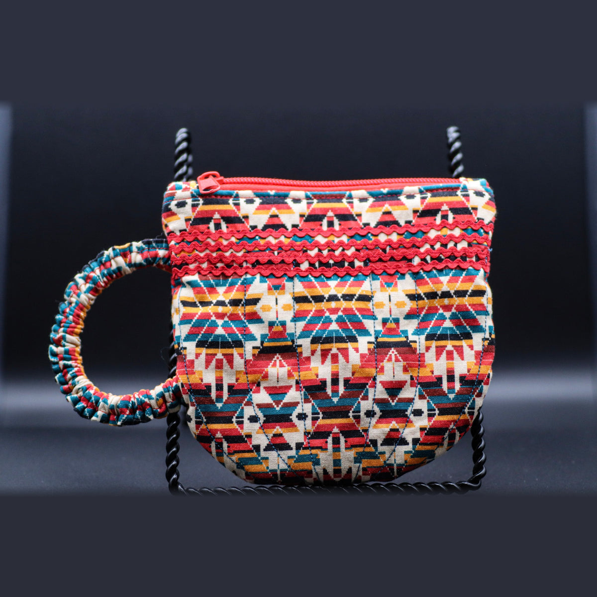 Teacup-shaped quilted bag in red and cream stripes, front view