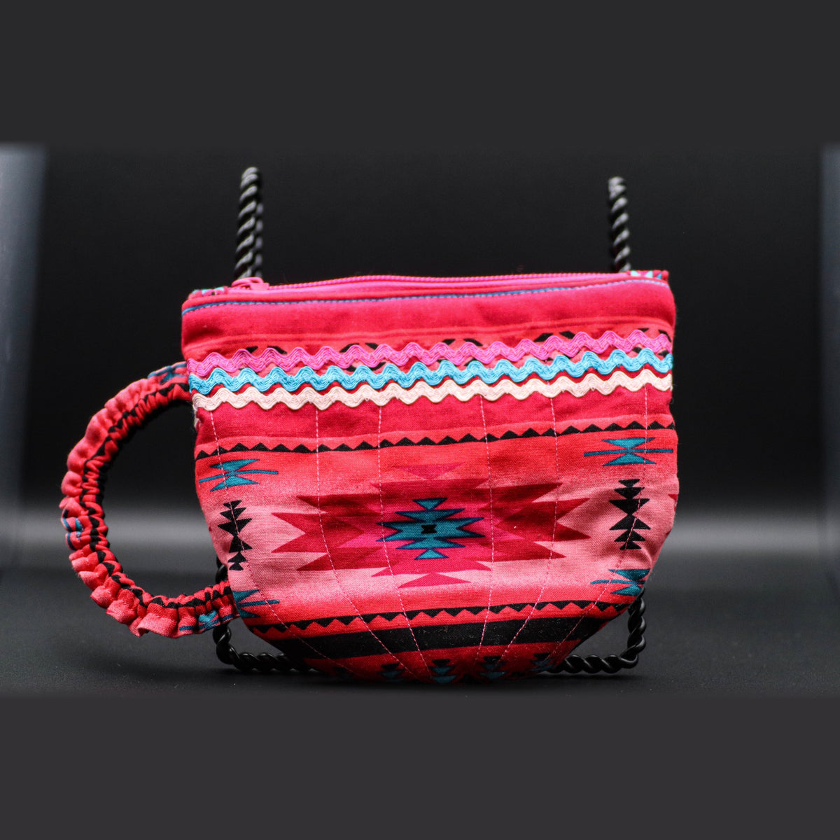 Teacup-shaped quilted bag in bright pink, front view