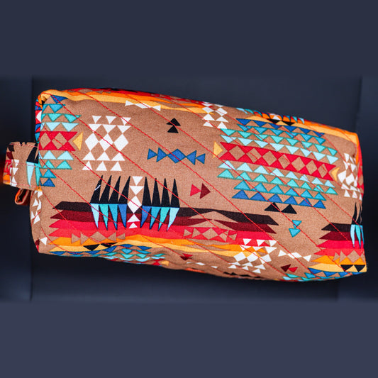 Boxy quilted bag in tan with turquoise and red triangles, front view